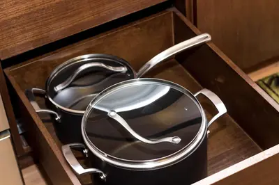 a pair of pans sitting in a drawer at Fantastic Philly Fully Furnished Apartments in Philadelphia