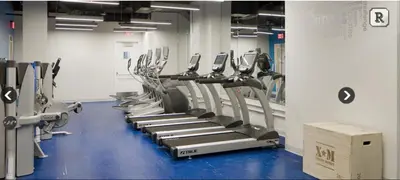 a gym with a row of treadmills at Fantastic Philly Fully Furnished Apartments in Philadelphia