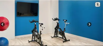 two exercise bikes in a room with blue walls at Fantastic Philly Fully Furnished Apartments in Philadelphia
