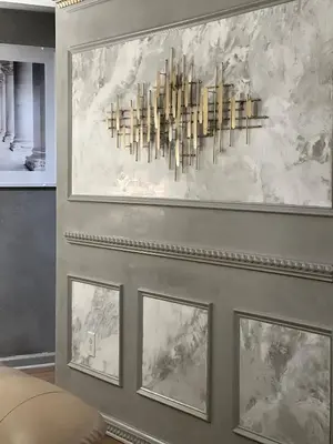 a chandelier hanging on a wall with four pictures at Chateau Suites in Norristown