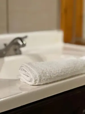 a white towel sitting on top of a bathroom sink at Chateau Suites in Norristown