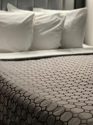 a close up of a bed with white pillows at Chateau Suites in Norristown