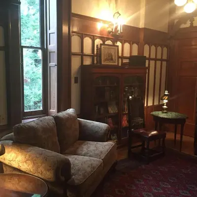 a living room with a couch and a table at The Inn at Centre Park in Reading