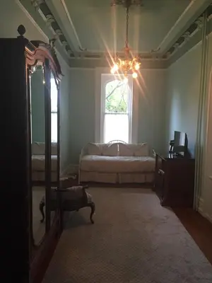 a bedroom with a bed and a mirror and a window at The Inn at Centre Park in Reading