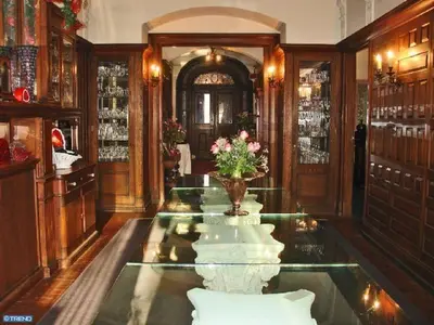 a room with a glass table and a vase of flowers at The Inn at Centre Park in Reading