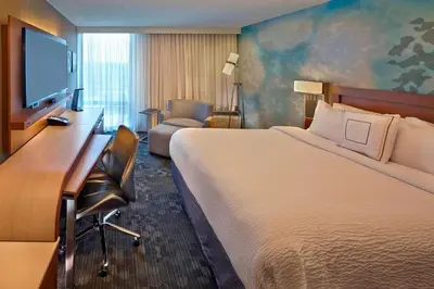 a hotel room with a large bed and a desk at Courtyard by Marriott Philadelphia City Avenue in Philadelphia