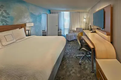 a hotel room with a large bed and a desk at Courtyard by Marriott Philadelphia City Avenue in Philadelphia