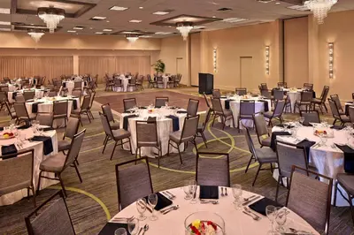 a banquet hall with white tables and chairs at Courtyard by Marriott Philadelphia City Avenue in Philadelphia