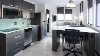 a kitchen with a counter and a chair in it at Hyatt House Jersey City in Jersey City