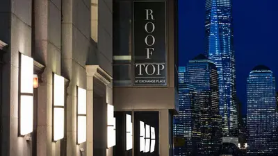 a tall building with a sign for the hotel top at Hyatt House Jersey City in Jersey City