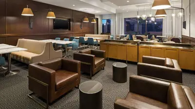 a restaurant with chairs and tables and a waiting room at Hyatt House Jersey City in Jersey City
