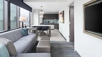 a living room with a couch and a television at Hyatt House Jersey City in Jersey City
