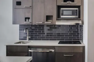 a kitchen with a sink and a microwave at Hyatt House New York/Chelsea in New York