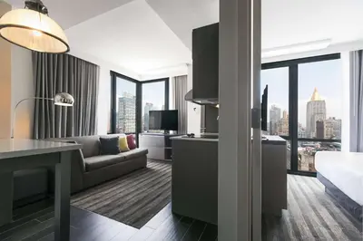 a kitchen and living room with a view of a city at Hyatt House New York/Chelsea in New York