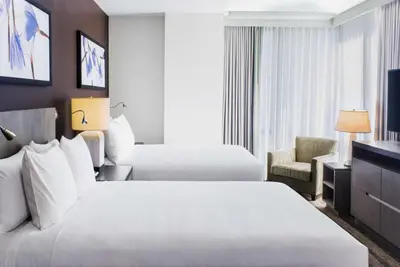 a hotel room with two beds and a television at Hyatt House New York/Chelsea in New York