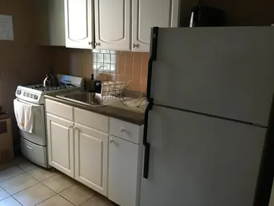 a kitchen with a white refrigerator and a sink at Beauty Near Times Square in New York