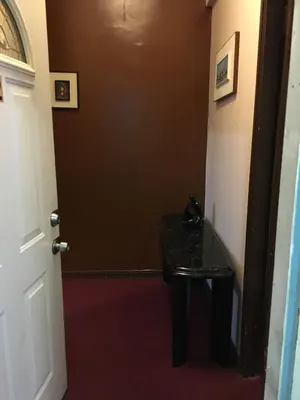 a hallway with a black table and a door at Beauty Near Times Square in New York