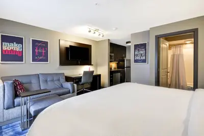 a hotel room with a bed and a living room at TownePlace Suites by Marriott Dover Rockaway in Dover