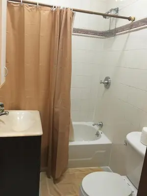 a bathroom with a tub and a toilet and a sink at Times Square Perfect Home in New York