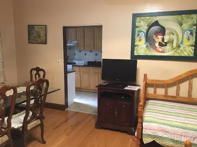 a living room with a television and a kitchen at Times Square Perfect Home in New York