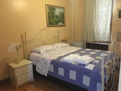 a bedroom with a bed with blue and white sheets at Times Square Perfect Home in New York