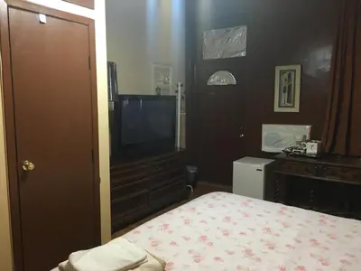 a bedroom with a bed and a flat screen tv at Times Square Perfect Home in New York