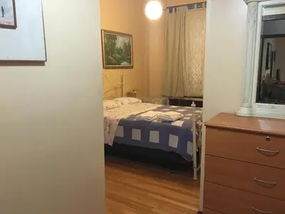 a bedroom with a bed and a dresser at Times Square Perfect Home in New York