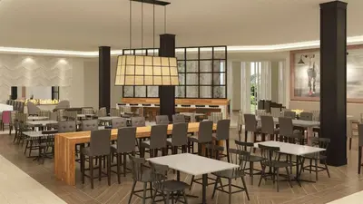a restaurant with tables and chairs in a room at Embassy Suites By Hilton Berkeley Heights in Berkeley Heights