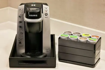 a kreme coffee maker with cups in a box at Embassy Suites By Hilton Berkeley Heights in Berkeley Heights