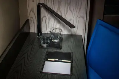 a wooden table with two glasses on top of it at Doubletree By Hilton New York Times Square West in New York