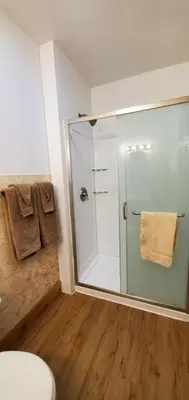 a bathroom with a glass shower and a toilet at Lakewood Lodge & Restaurant in Lakewood