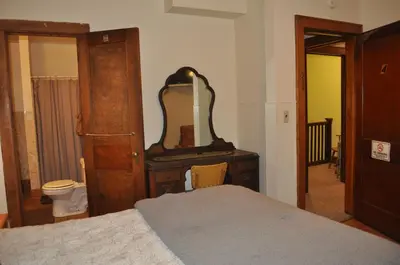 a bedroom with a bed and a dresser with a mirror at Lakewood Lodge & Restaurant in Lakewood