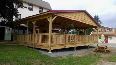 a wooden gazebo in front of a house at Lakewood Lodge & Restaurant in Lakewood
