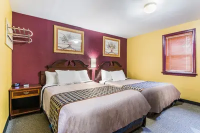 a hotel room with two beds in a room at Cottage Inn - Grantville in Grantville