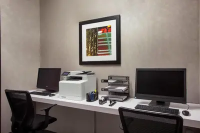 an office with a desk with a computer and a printer at Four Points by Sheraton Manhattan Midtown West in New York
