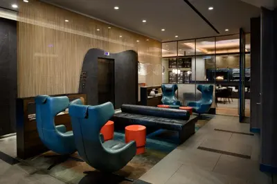 a lobby with chairs and a couch and a table at LUMA Hotel - Times Square in New York