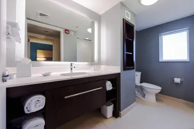 a bathroom with a sink and a mirror and a toilet at Residence Inn by Marriott Philadelphia Glen Mills/Concordville in Glen Mills