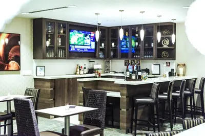 a bar in a restaurant with tables and chairs at Residence Inn by Marriott Philadelphia Glen Mills/Concordville in Glen Mills