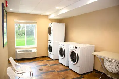a laundry room with a washer and dryer and a window at Candlewood Suites York by IHG in York