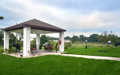 a gazebo with a table and chairs in a field at Candlewood Suites York by IHG in York