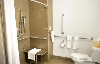 a bathroom with a toilet and a shower with towels at Candlewood Suites York by IHG in York