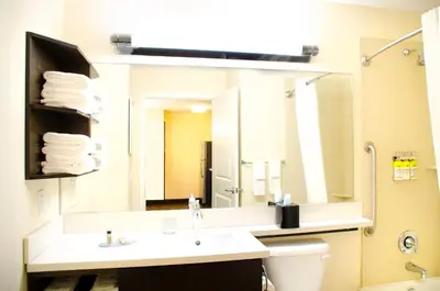 a bathroom with a sink and a large mirror at Candlewood Suites York by IHG in York