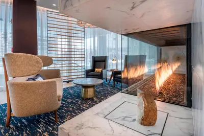 a lobby with a chair and a fireplace at Residence Inn by Marriott Jersey City in Jersey City