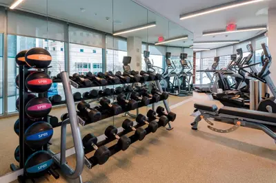 a gym with rows of treadmills and machines at Residence Inn by Marriott Jersey City in Jersey City