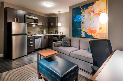 a living room with a couch and a kitchen at Residence Inn by Marriott Jersey City in Jersey City