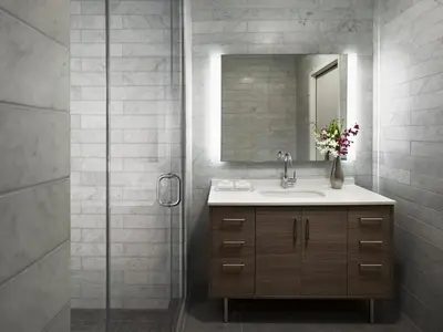 a bathroom with a sink and a shower with a mirror at AKA University City in Philadelphia