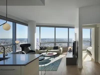 a kitchen and living room with a view of the city at AKA University City in Philadelphia