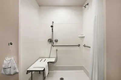 a white bathroom with a shower and a sink at Hampton Inn & Suites Mount Joy/Lancaster West, Pa in Manheim