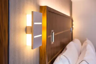 a bedroom with a mirror and a bed with pillows at Crowne Plaza HY36 Midtown Manhattan by IHG in New York
