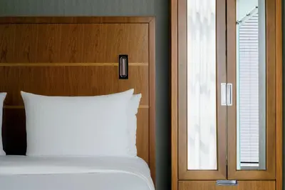 a bed with a white pillow next to a window at Crowne Plaza HY36 Midtown Manhattan by IHG in New York